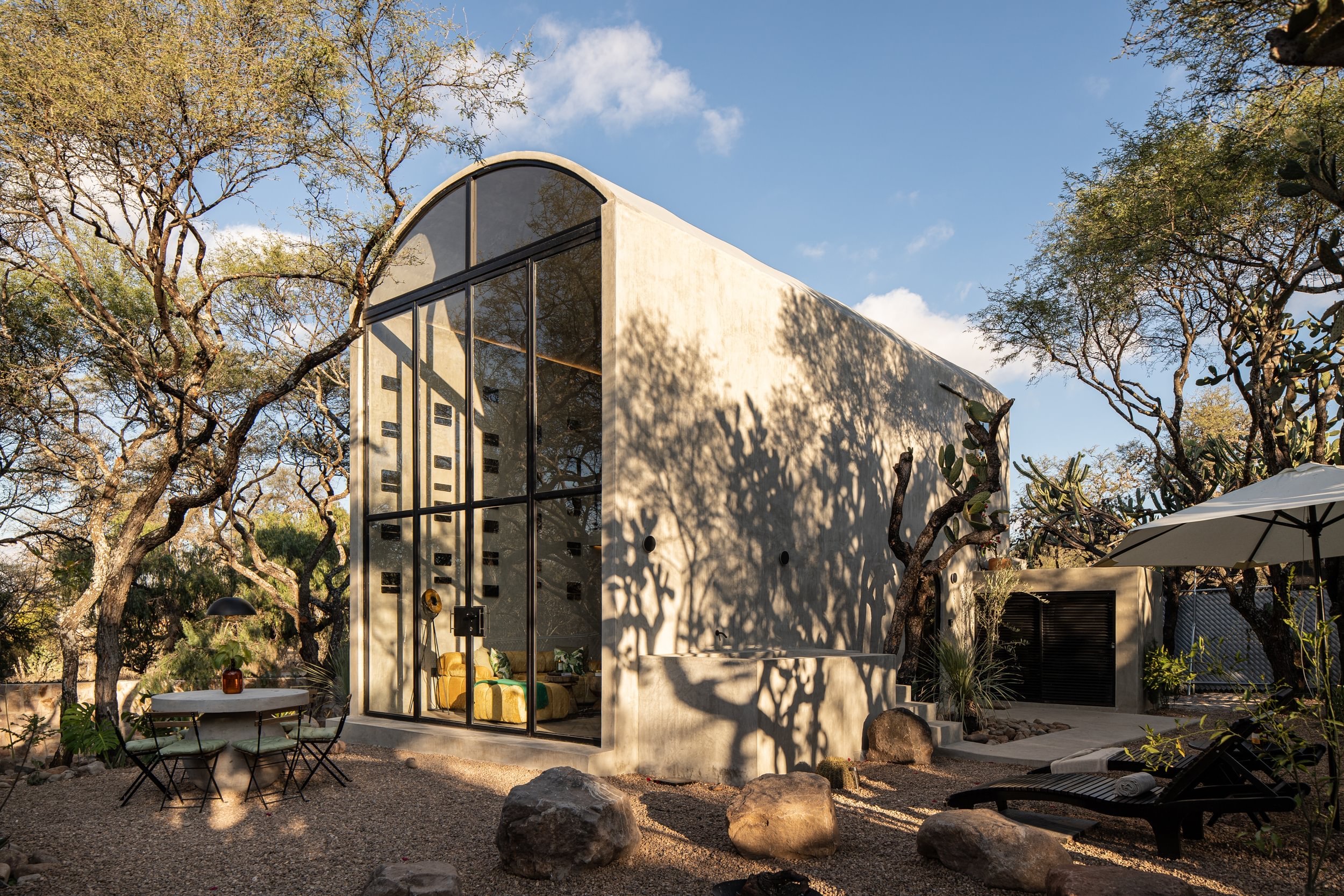Glass-fronted villa among trees in San Miguel de Allende