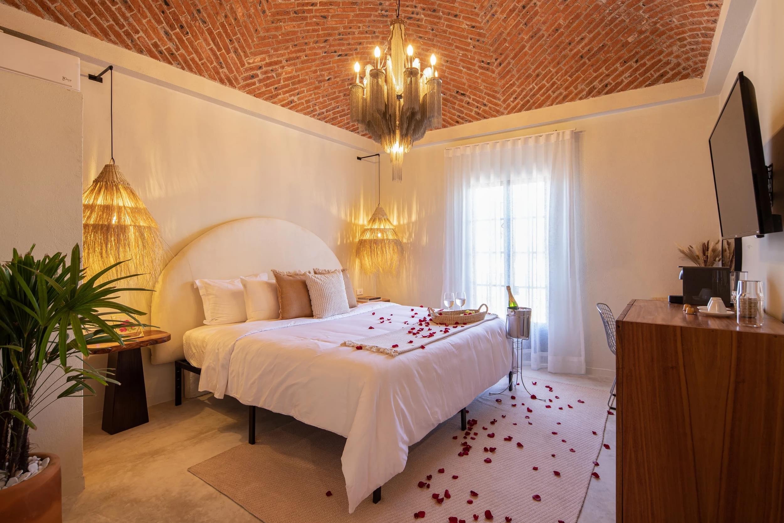 Bedroom under a brick vaulted ceiling at Hotel Del Pueblito