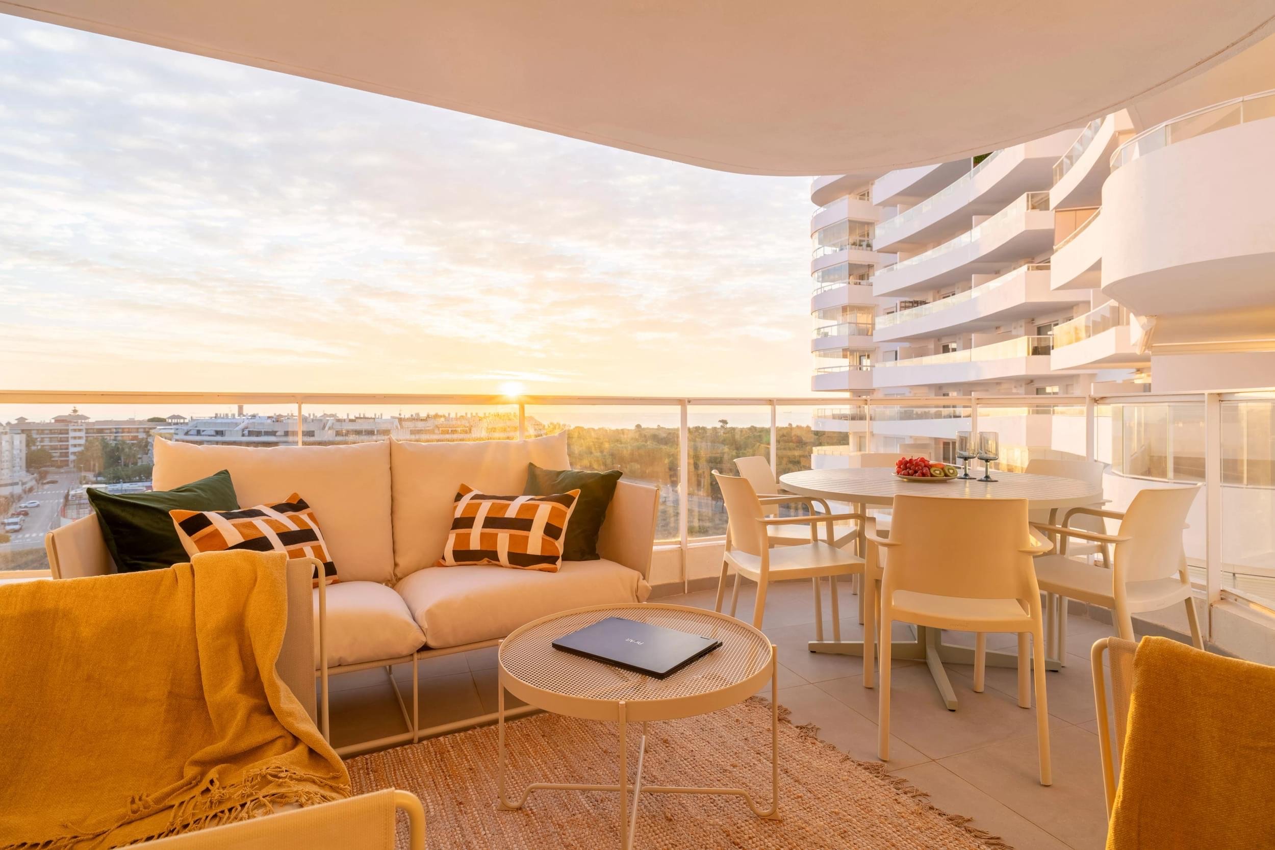 Sunset balcony with sofa and dining table
